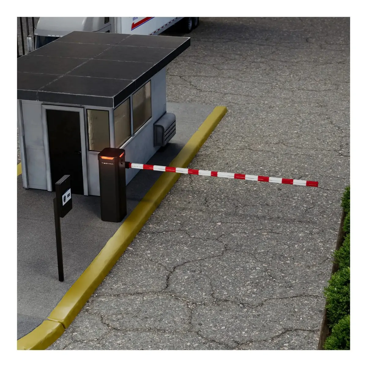 Barrier arm gate operator controlling a campus vehicle entry lane.