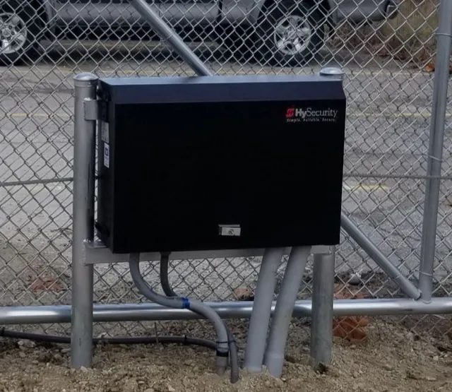 HySecurity gate operator mounted on a commercial chain link perimeter.