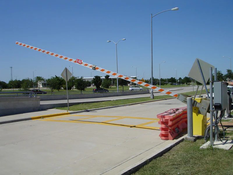 HySecurity StrongArm barrier gate with raised boom at a vehicle access lane.