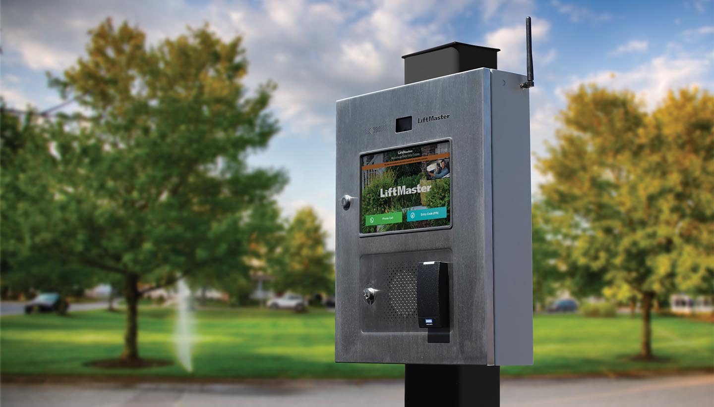 LiftMaster CAPXLV smart video intercom with touchscreen at a community entrance.